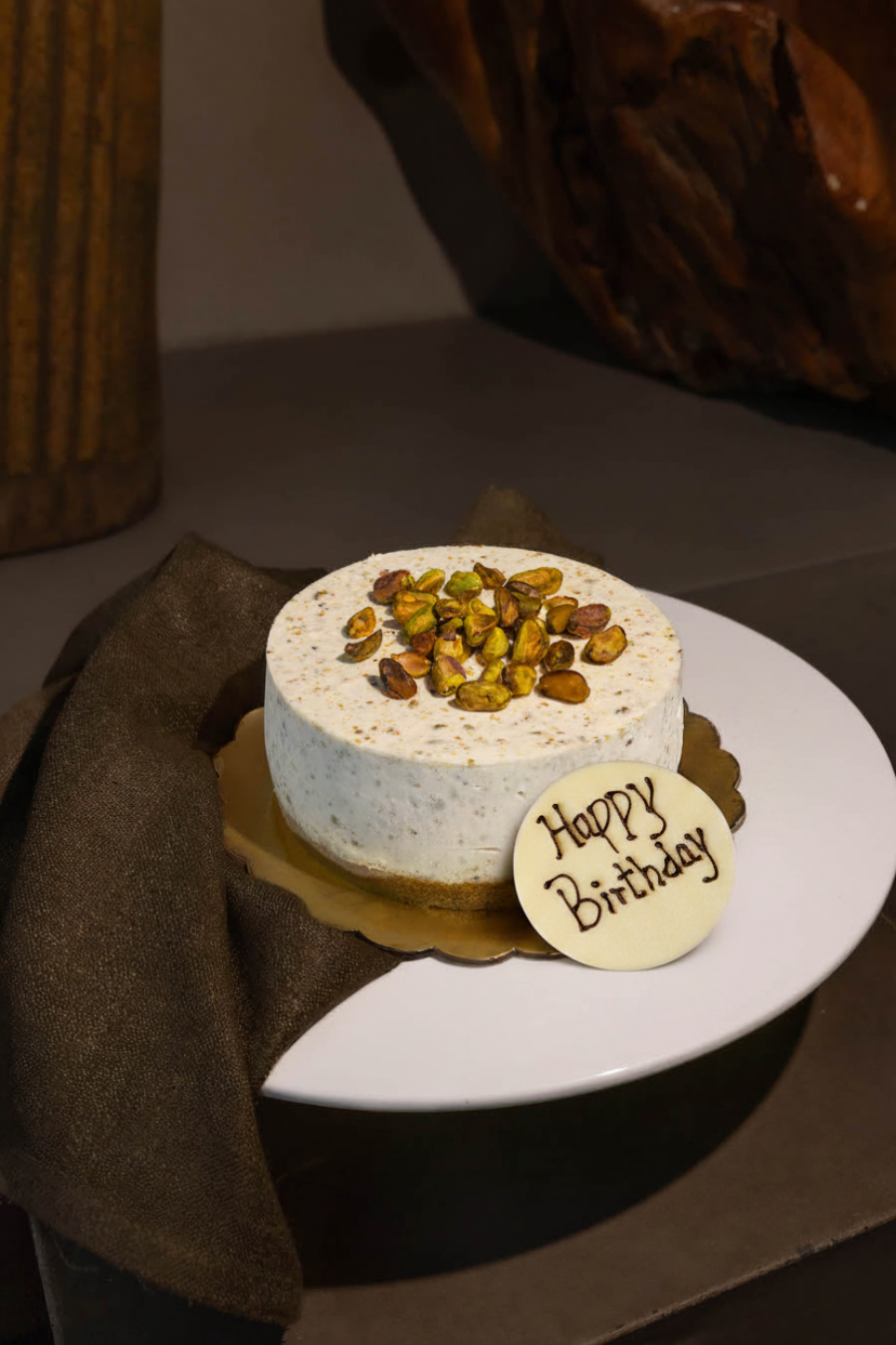 White Chocolate Happy Birthday plaque on Pistachio Cheesecake